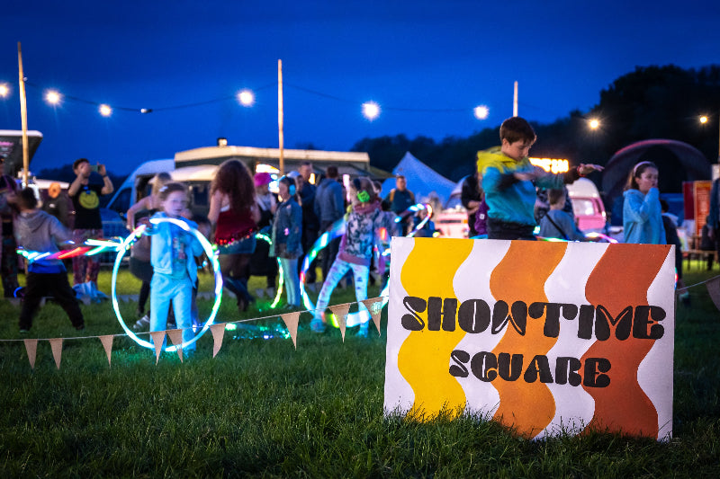 Children playing with glowing hoops at Glampfest festival in Yorkshire